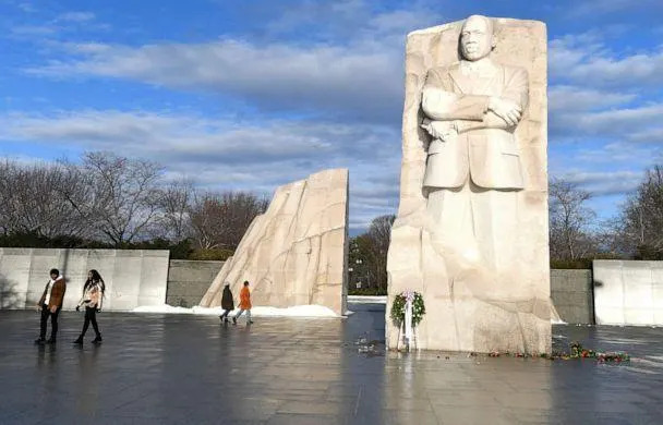 PHOTO: Visitors walk past the Martin Luther King, Jr. Memorial as the sun breaks through clouds after a stormy night, in Washington, D.C., Jan. 17, 2022. (Mike Theiler/Reuters)
