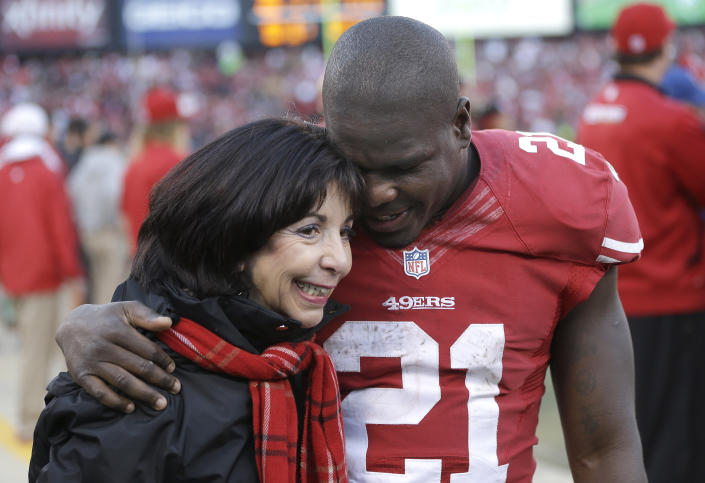 San Francisco 49ers running back Frank Gore (21) hugs former owner and current co-chair of the 49ers Denise DeBartolo York during the fourth quarter of an NFL football game against the Arizona Cardinals in San Francisco, Sunday, Dec. 30, 2012. The 49ers won 27-13. (AP Photo/Marcio Jose Sanchez)