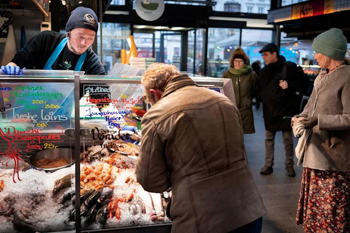Customers at a fish market in Copenhagen on Feb. 1, as Denmark became the first EU country to lift coronavirus restrictions despite record case numbers, citing its high vaccination rates and the lesser severity of Omicron variant. 
