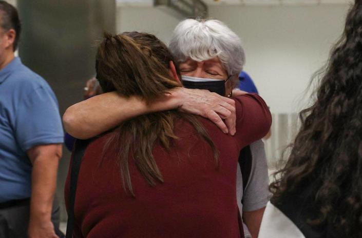 Graciela Silva, right, who was on the Red Air flight that caught fire, reunites with her daughter, Jasmine Rincon, after getting off the plane on Tuesday, June 21, 2022, at Miami International Airport.